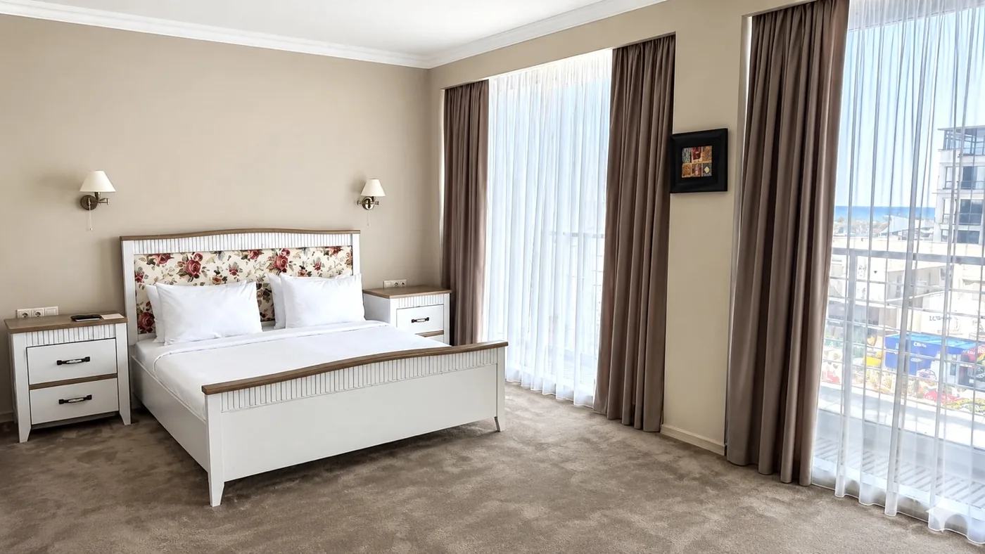 The apartment's bedroom: floor-to-ceiling windows and a view of the resort